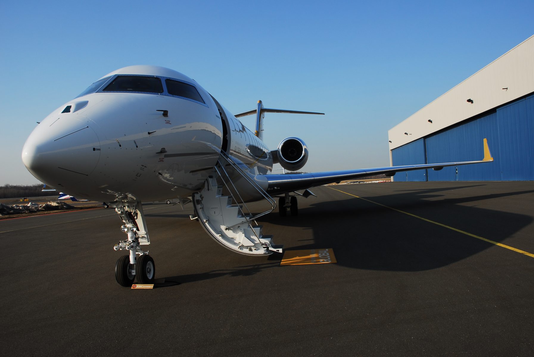 Bombardier Global private jet on ramp with steps deployed